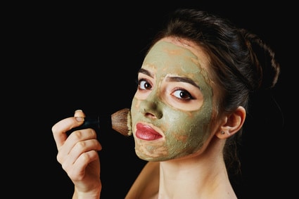 Portrait Of A Young Attractive Woman In A Cosmetic Mask . Girl Doing Beauty Treatments